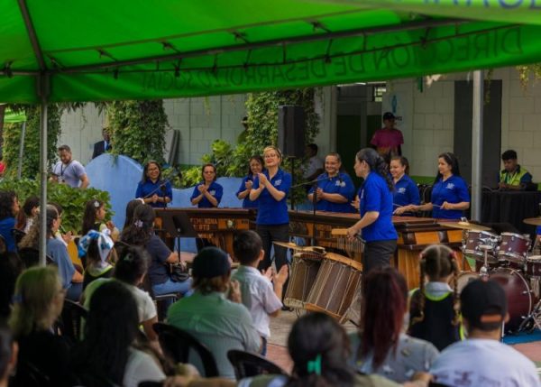 Integrantes de la Marimba Femenina de Concierto ejecutando el instrumento nacional frente a cientos de niños durante una jornada educativa.